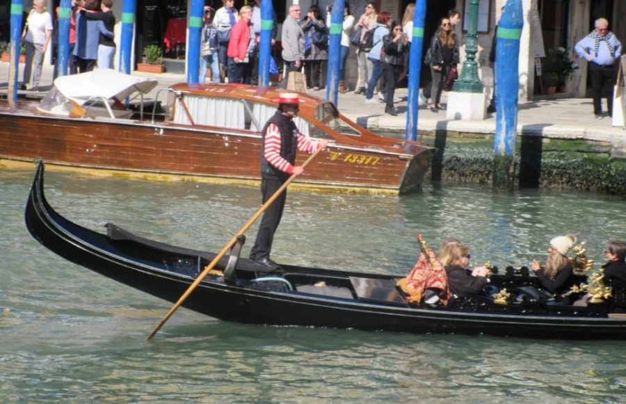 Gondolieri steer on the right.