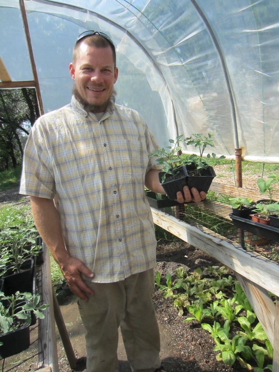 Greg holds two of his customers&rsquo; favorite sweet tomatoes: Sun Gold.