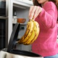 woman-throwing-away-out-of-date-food-in-refrigerator-picture-id506513816